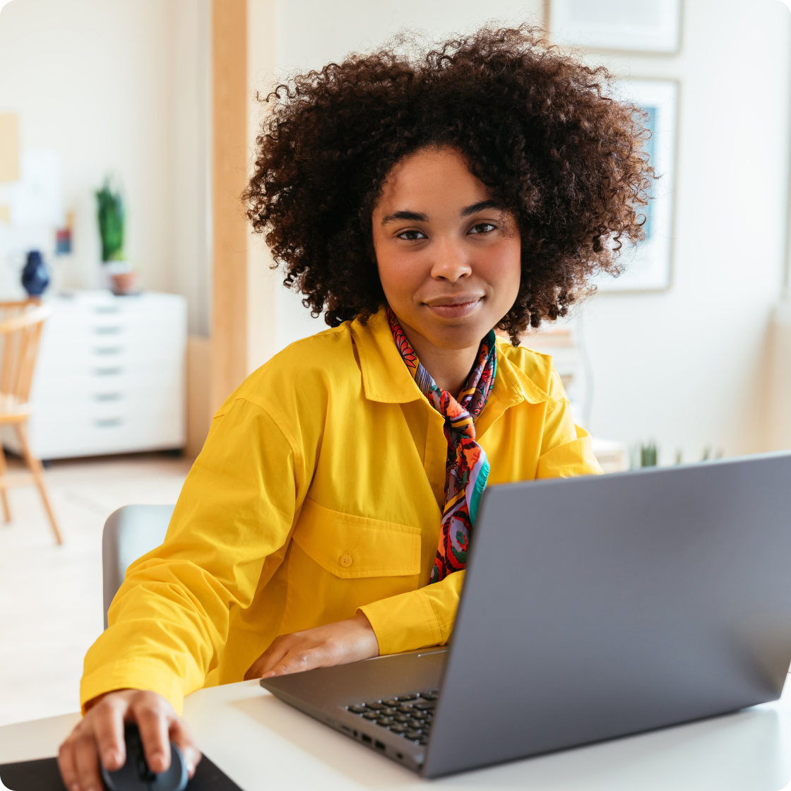 Image of a woman using a laptop in an office setting