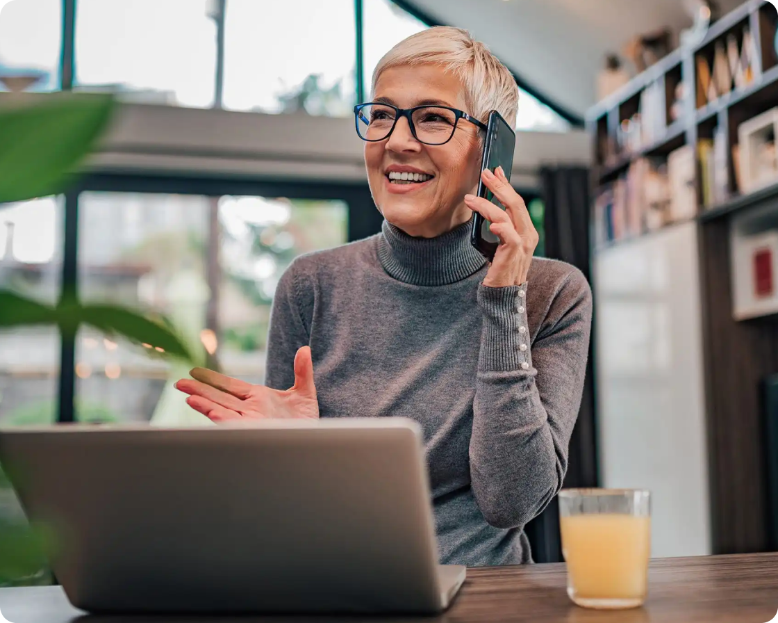 Image of a woman using a cellphone at her desk