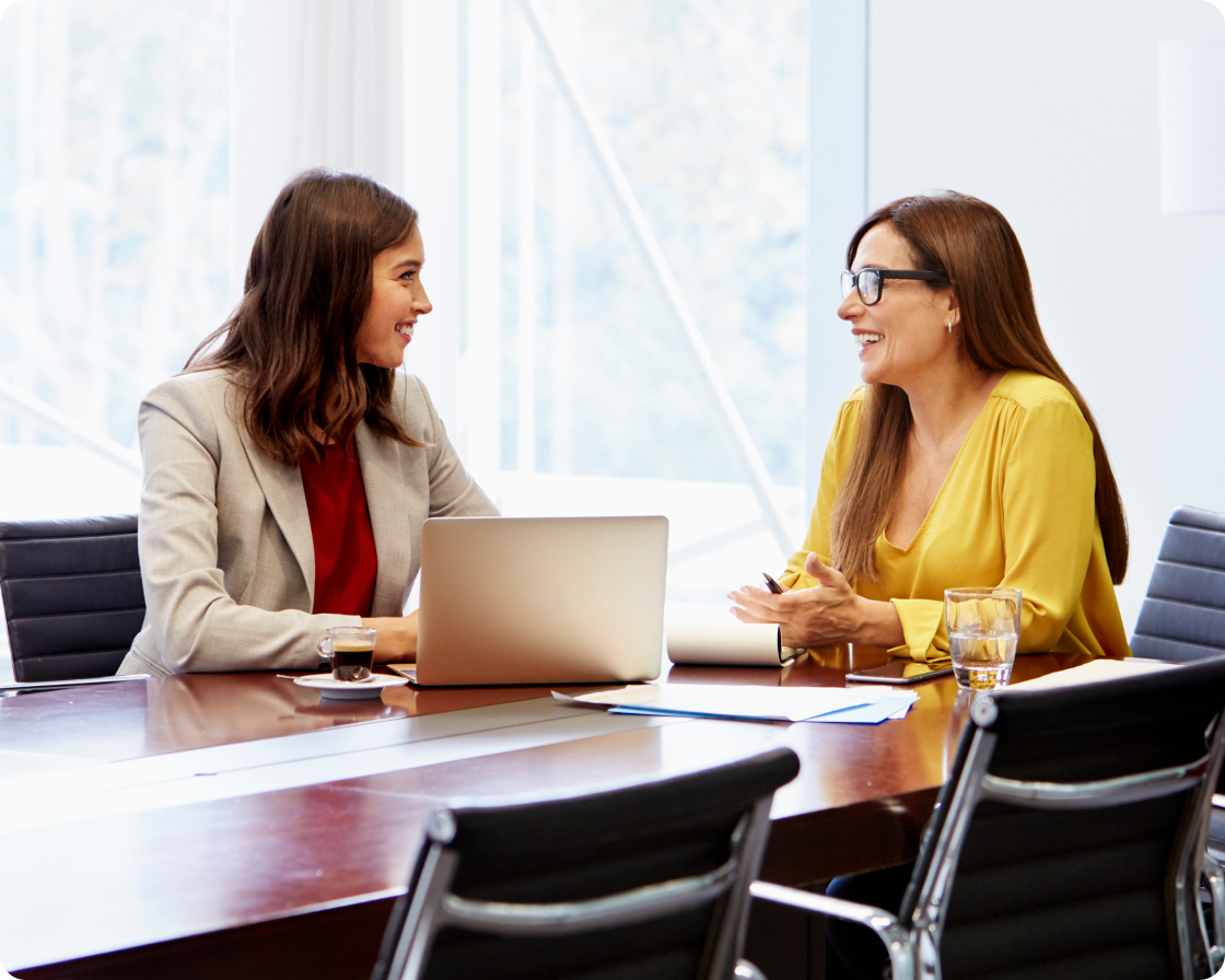 Image of two women in a conference room