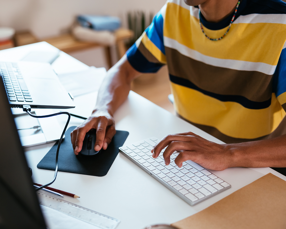 Image of person using a mouse and keyboard