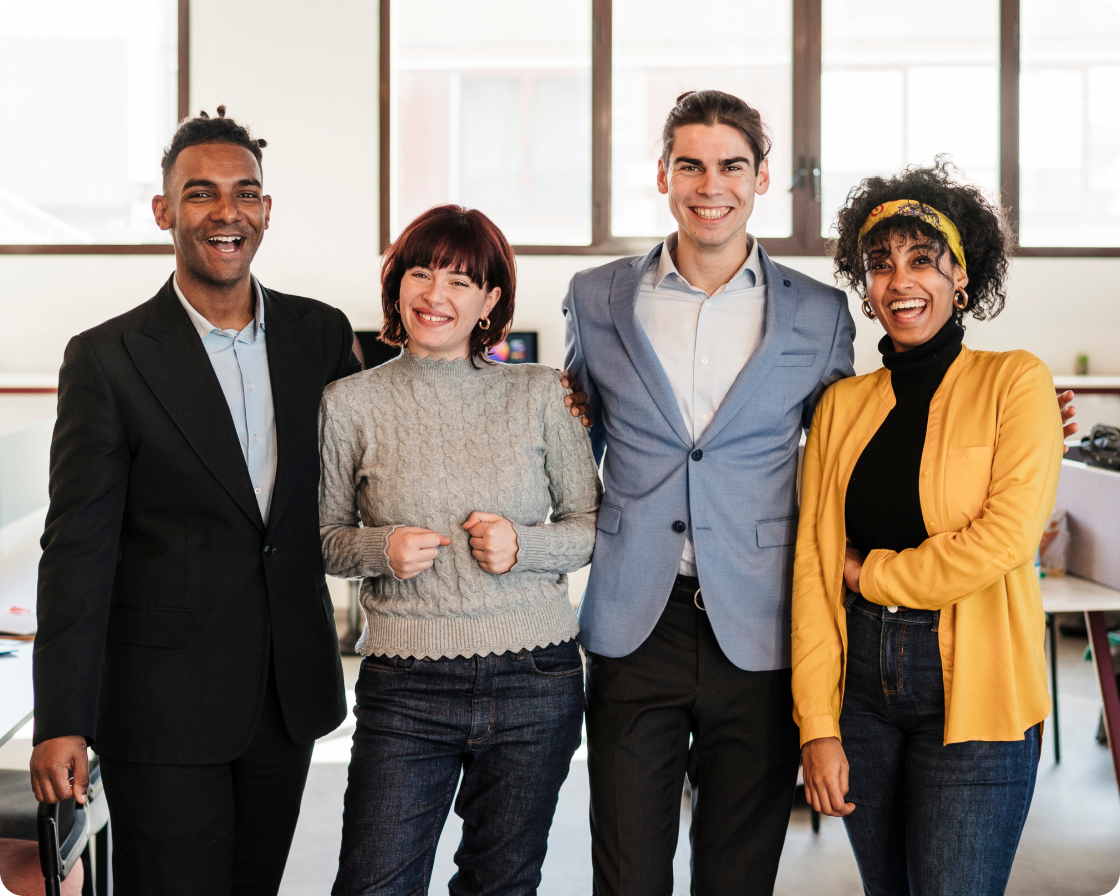 Group of coworkers in an office smiling together